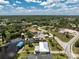 Waterfront home features a boat dock, a metal roof, and verdant tropical landscaping at 3420 Santa Clara Dr, Punta Gorda, FL 33983