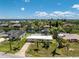 Aerial view of a waterfront home with mature landscaping and canal access offering a picturesque Florida lifestyle at 3420 Santa Clara Dr, Punta Gorda, FL 33983