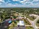 Waterfront home features a boat dock, a metal roof, and verdant tropical landscaping at 3420 Santa Clara Dr, Punta Gorda, FL 33983