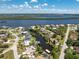 An aerial view of a waterfront home, featuring a private boat dock and beautiful canal access to the bay and open waters at 3420 Santa Clara Dr, Punta Gorda, FL 33983
