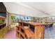 The custom wooden bar area on the patio features built-in shelving and seating for relaxed entertainment at 3420 Santa Clara Dr, Punta Gorda, FL 33983