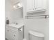Bathroom featuring a sink, mirror, cabinet and toilet with tiled floors at 3420 Santa Clara Dr, Punta Gorda, FL 33983