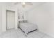 Minimalist bedroom with white walls, ceiling fan, and tile flooring at 3420 Santa Clara Dr, Punta Gorda, FL 33983