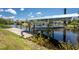 Waterfront property boasts a private boat dock with a boat lift offering direct access to the open water at 3420 Santa Clara Dr, Punta Gorda, FL 33983
