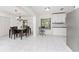 Bright dining area with modern chandelier, seamlessly connected to the kitchen with great natural light at 3420 Santa Clara Dr, Punta Gorda, FL 33983