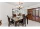 Bright dining room with contemporary chandelier, china cabinet, and tile flooring at 3420 Santa Clara Dr, Punta Gorda, FL 33983