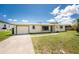 Well-maintained single-story home with a one-car garage, lush green lawn, and charming curb appeal at 3420 Santa Clara Dr, Punta Gorda, FL 33983