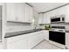 Modern kitchen with stainless steel appliances, sleek countertops, and ample cabinet space with tile floors at 3420 Santa Clara Dr, Punta Gorda, FL 33983