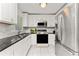 Bright kitchen with white cabinets, stainless steel appliances, and modern countertops at 3420 Santa Clara Dr, Punta Gorda, FL 33983
