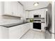 Modern kitchen with stainless steel appliances, sleek countertops, and ample cabinet space with tile floors at 3420 Santa Clara Dr, Punta Gorda, FL 33983