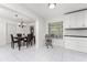 Bright dining area with modern chandelier, seamlessly connected to the kitchen with great natural light at 3420 Santa Clara Dr, Punta Gorda, FL 33983