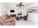 Bright living room with tile floors, a ceiling fan, comfortable furniture, and a view to the dining area at 3420 Santa Clara Dr, Punta Gorda, FL 33983