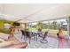 The screened patio is furnished with a bar, dining table, and seating, with scenic outdoor views at 3420 Santa Clara Dr, Punta Gorda, FL 33983