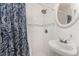 Shower with blue patterned curtain, shower head, and pedestal sink at 3420 Santa Clara Dr, Punta Gorda, FL 33983