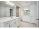 Bright bathroom featuring double vanities, modern fixtures and neutral color palette at 35280 Big Hawk Ln, Zephyrhills, FL 33541