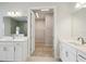 A bright bathroom with double vanities leading to walk-in closet at 35280 Big Hawk Ln, Zephyrhills, FL 33541