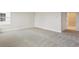 A bedroom with carpet, white trim and baseboards plus a doorway to the right at 35280 Big Hawk Ln, Zephyrhills, FL 33541
