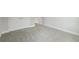 A bedroom with carpet, white trim and baseboards plus a doorway to the right at 35280 Big Hawk Ln, Zephyrhills, FL 33541