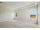 Bright bedroom with large windows letting in natural light and plush carpeting throughout at 35280 Big Hawk Ln, Zephyrhills, FL 33541