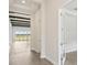 Hallway featuring wood-look flooring, decorative ceiling beams, and neutral-toned walls at 35280 Big Hawk Ln, Zephyrhills, FL 33541