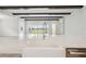 Open-concept kitchen featuring an island with sink, stainless steel appliances, and view to backyard at 35280 Big Hawk Ln, Zephyrhills, FL 33541