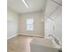 Well-lit laundry room featuring a utility sink and wire shelving for storage at 35280 Big Hawk Ln, Zephyrhills, FL 33541