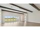 Spacious living room with expansive windows providing natural light and wood-look flooring at 35280 Big Hawk Ln, Zephyrhills, FL 33541