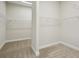 A well-organized walk-in closet featuring carpet, white walls, and wire shelving for ample storage at 35280 Big Hawk Ln, Zephyrhills, FL 33541