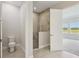Bathroom with glass shower, white toilet, and neutral tile at 35571 Stableton Ln, Zephyrhills, FL 33541
