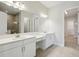 Bathroom featuring double vanity, quartz countertop, and large mirror in the main bathroom at 35571 Stableton Ln, Zephyrhills, FL 33541