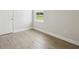 Hardwood floors and window allowing natural light into the bedroom at 35571 Stableton Ln, Zephyrhills, FL 33541
