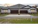 Charming villa with brick driveway, two-car garage, and stone accents on a well-maintained lawn at 35571 Stableton Ln, Zephyrhills, FL 33541