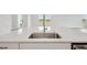Elegant quartz countertop with stainless steel sink and modern faucet in a bright, open kitchen at 35571 Stableton Ln, Zephyrhills, FL 33541