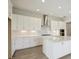 Modern kitchen with white cabinetry, stainless steel appliances, and a center island at 35571 Stableton Ln, Zephyrhills, FL 33541