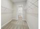 Carpeted walk-in closet with wire shelving units at 35571 Stableton Ln, Zephyrhills, FL 33541