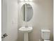 Bathroom featuring a pedestal sink and an oval mirror at 35579 Stableton Ln, Zephyrhills, FL 33541