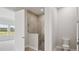 Modern bathroom with a glass-enclosed shower and neutral tiling at 35579 Stableton Ln, Zephyrhills, FL 33541