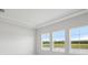 Bright and airy bedroom offering a serene view of the nearby pond at 35579 Stableton Ln, Zephyrhills, FL 33541