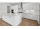 Modern kitchen with stainless appliances, white cabinets, and a large island at 35579 Stableton Ln, Zephyrhills, FL 33541