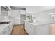 Modern kitchen featuring white cabinets, stainless steel appliances, and a large island at 35579 Stableton Ln, Zephyrhills, FL 33541