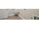 Laundry room featuring plank flooring and a utility sink at 35579 Stableton Ln, Zephyrhills, FL 33541