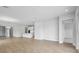 Open-concept living room with hardwood flooring, kitchen view, and natural light at 35579 Stableton Ln, Zephyrhills, FL 33541