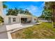 Inviting backyard with pergola-covered patio and lush lawn for outdoor living at 3801 Dr Martin Luther King Jr N St, St Petersburg, FL 33703