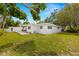 A lush green backyard features a covered patio and a well-maintained lawn at 3801 Dr Martin Luther King Jr N St, St Petersburg, FL 33703