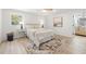Cozy bedroom with a neutral color palette, accent rug, and a view of the bathroom through an open doorway at 3801 Dr Martin Luther King Jr N St, St Petersburg, FL 33703