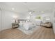 Bright and airy bedroom with neutral decor, a ceiling fan, and wood-look floors with a view to ensuite at 3801 Dr Martin Luther King Jr N St, St Petersburg, FL 33703