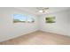 Light-filled bedroom with wood laminate floors and two windows offering a pleasant view at 3801 Dr Martin Luther King Jr N St, St Petersburg, FL 33703