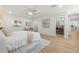 A clean and spacious bedroom with light wood floors, a stylish rug, and a view to ensuite at 3801 Dr Martin Luther King Jr N St, St Petersburg, FL 33703