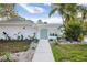 Charming home featuring a stylish walkway leading to a light blue front door and lush, tropical landscaping at 3801 Dr Martin Luther King Jr N St, St Petersburg, FL 33703