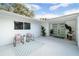 Inviting courtyard with seating area, plants, and stylish mint green double front door at 3801 Dr Martin Luther King Jr N St, St Petersburg, FL 33703